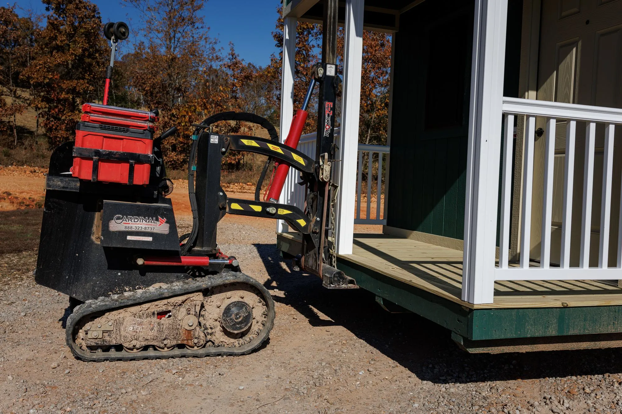 Close-up of a building mover lifting the porch end of a cabin