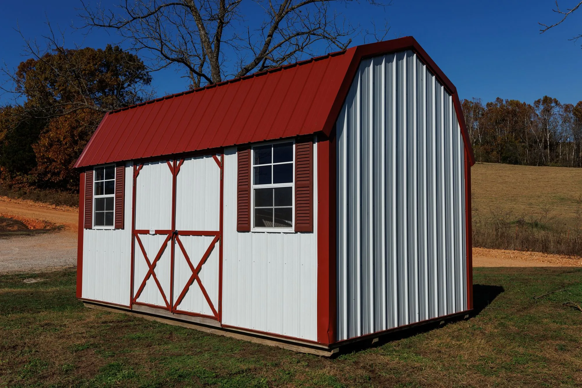 Lofted Garden Barn with white metal siding, red trim and roof