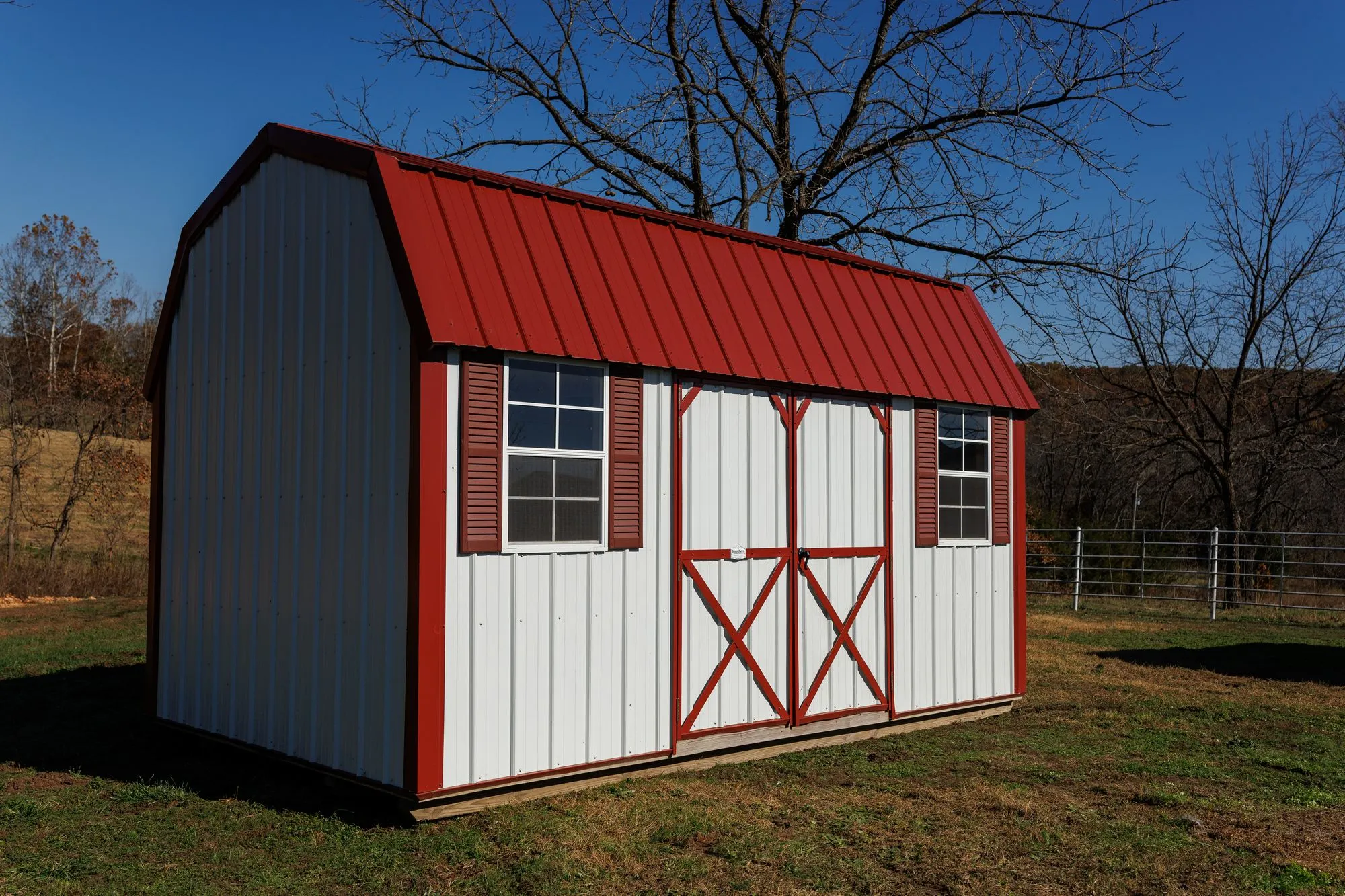 Lofted Garden Barn with white metal siding, red trim and roof