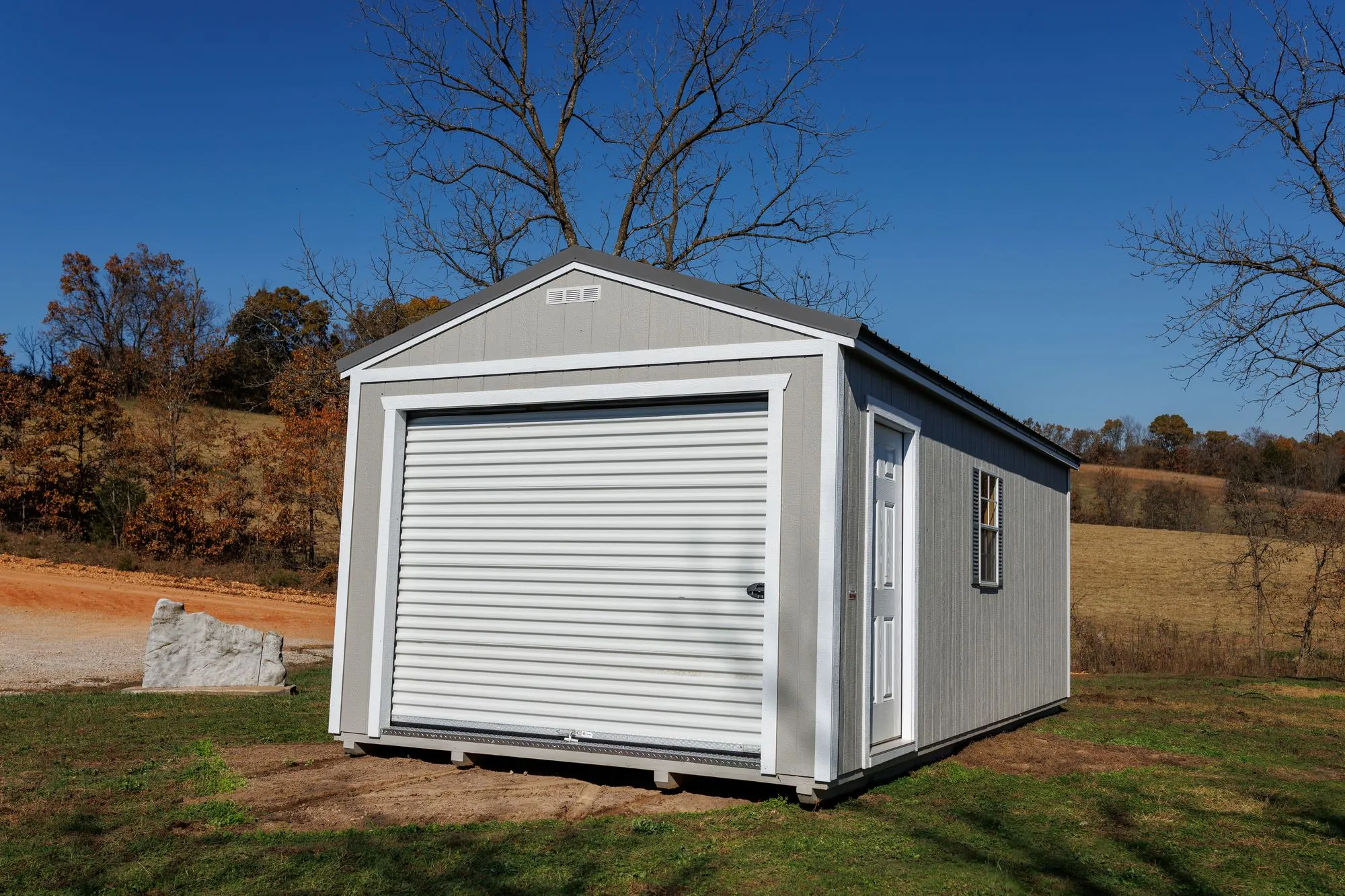 Portable Garage with gray siding, white trim, charcoal roof