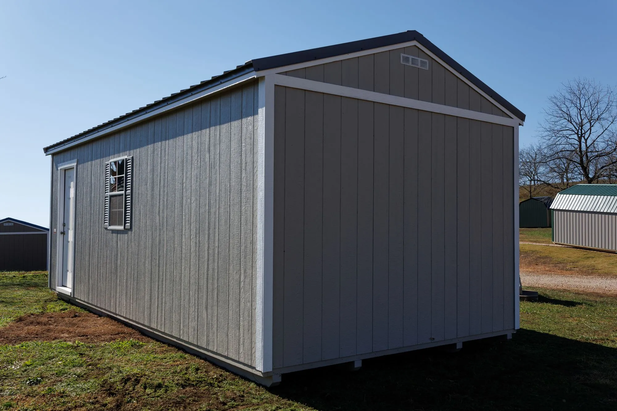 Portable Garage with gray siding, white trim, charcoal roof