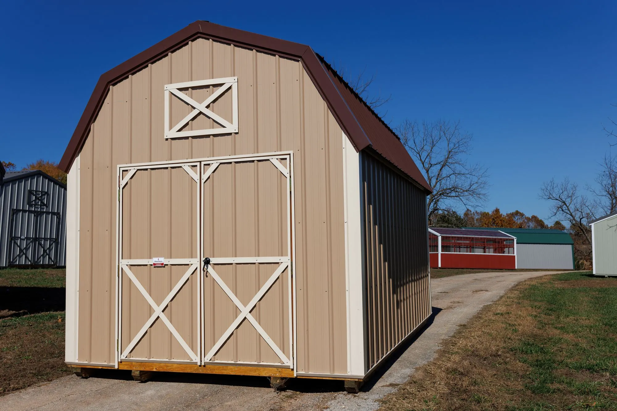 Lofted Barn with tan metal siding, white trim, brown roof