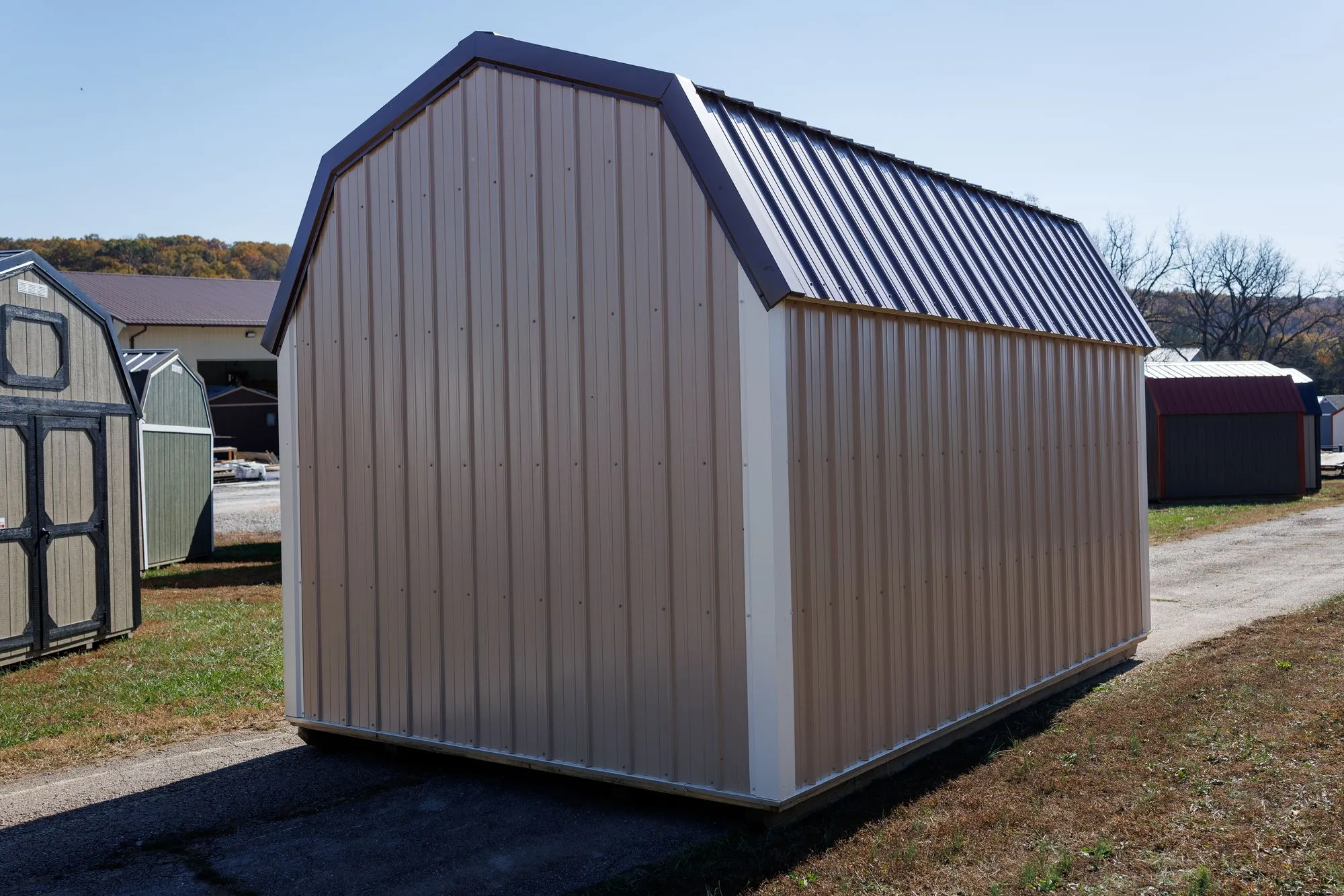 Lofted Barn with tan metal siding, white trim, brown roof