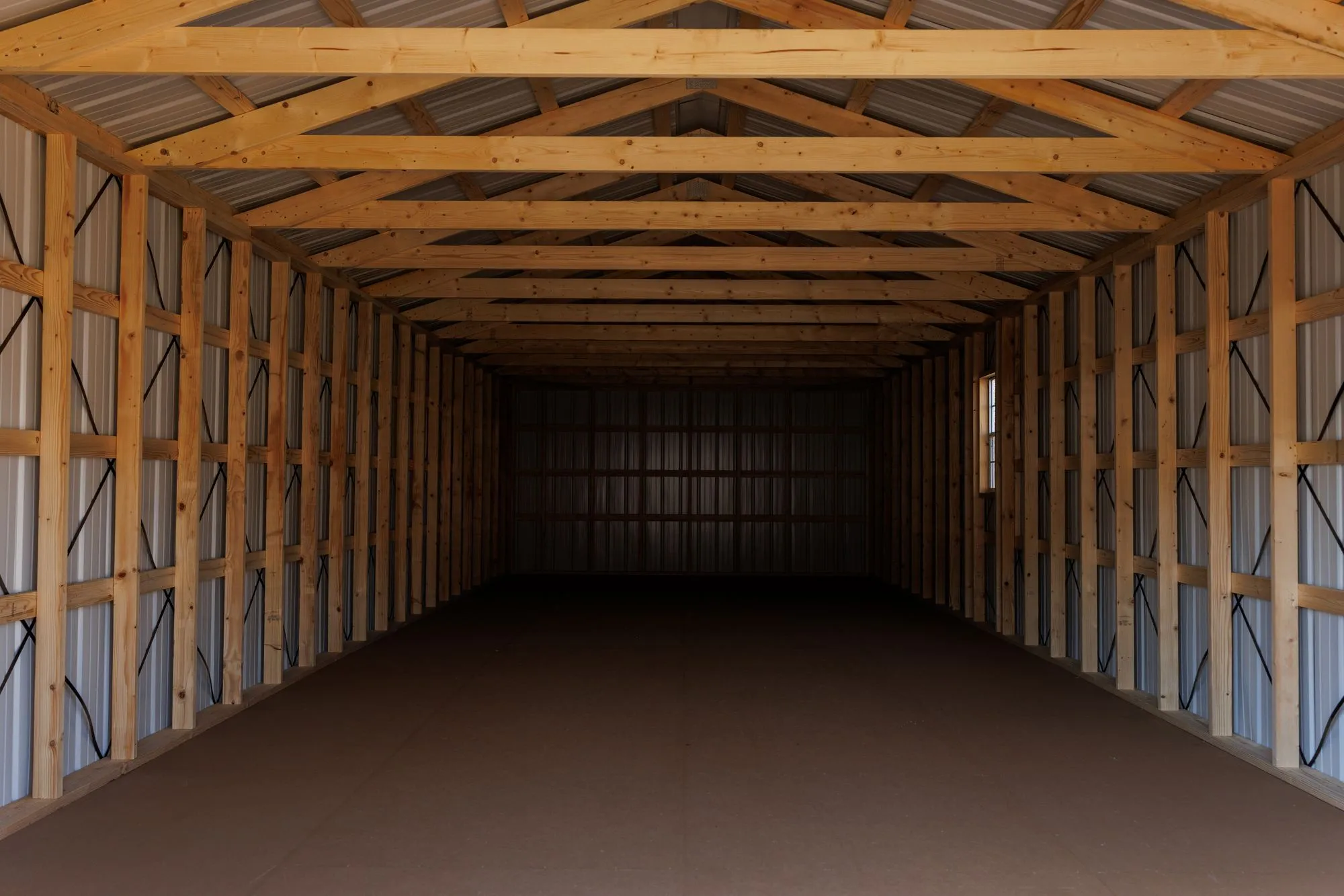 Inside a long Portable Garage, showing the framed walls and ceiling
