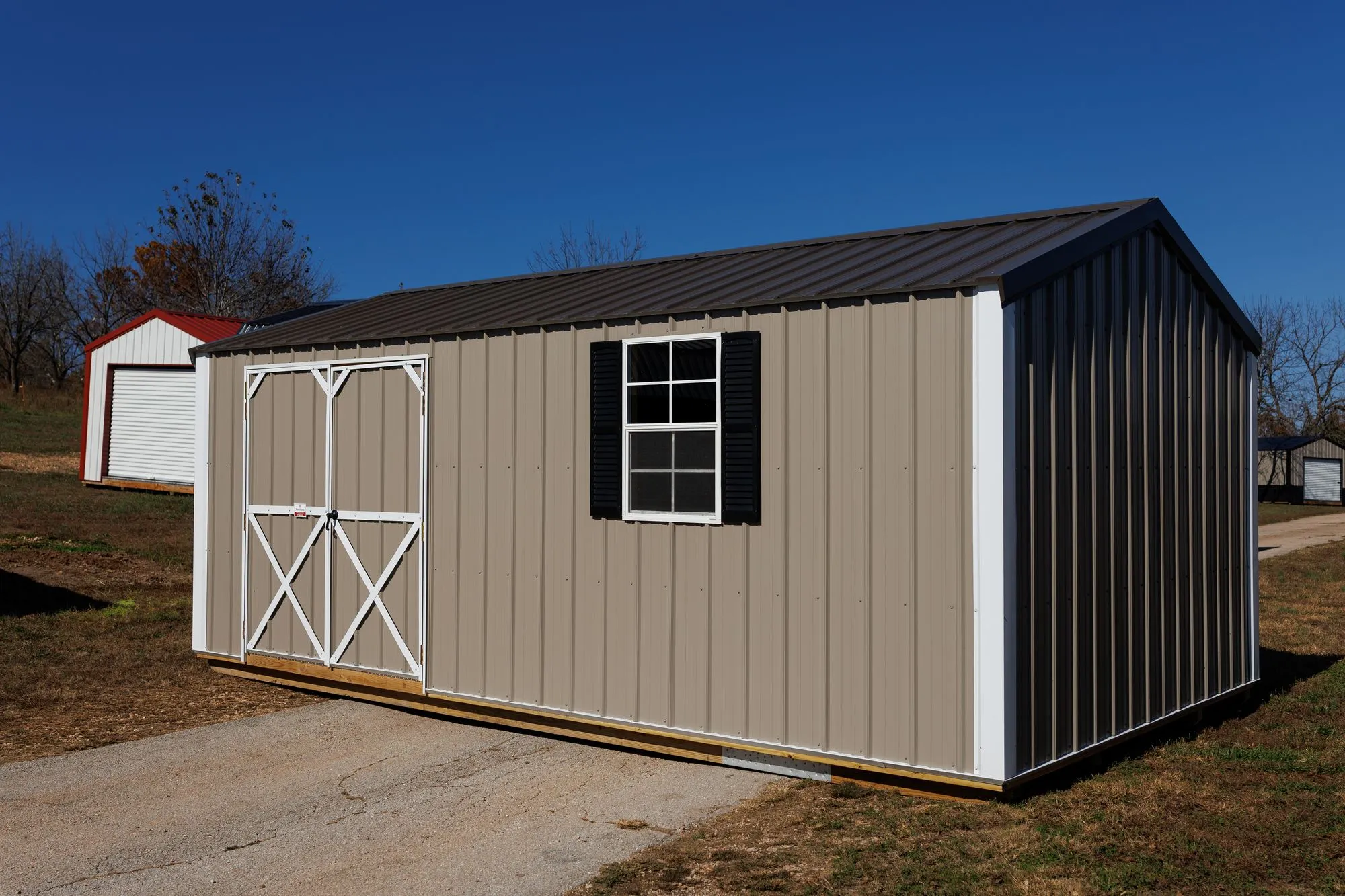 Garden Shed with clay metal siding, white trim, black roof, white X-braced doors