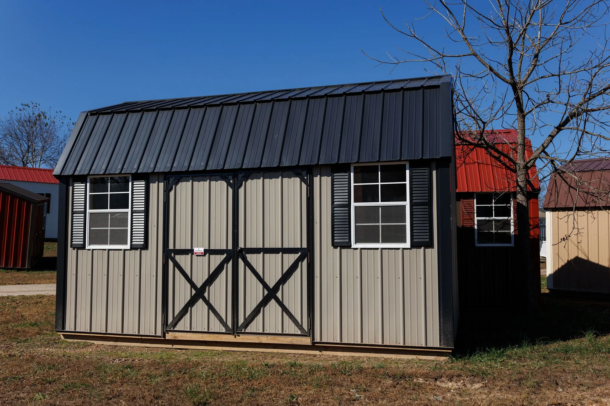 Lofted Garden Barn with clay-colored metal siding, black trim and roof