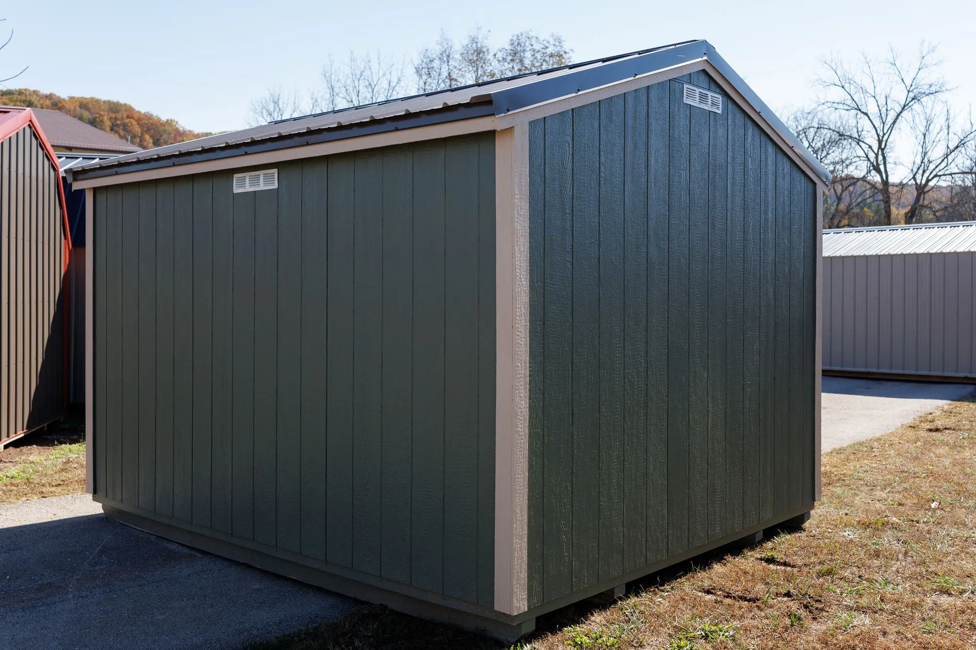 Garden Shed with sage siding, cream trim, black roof, cream-framed doors