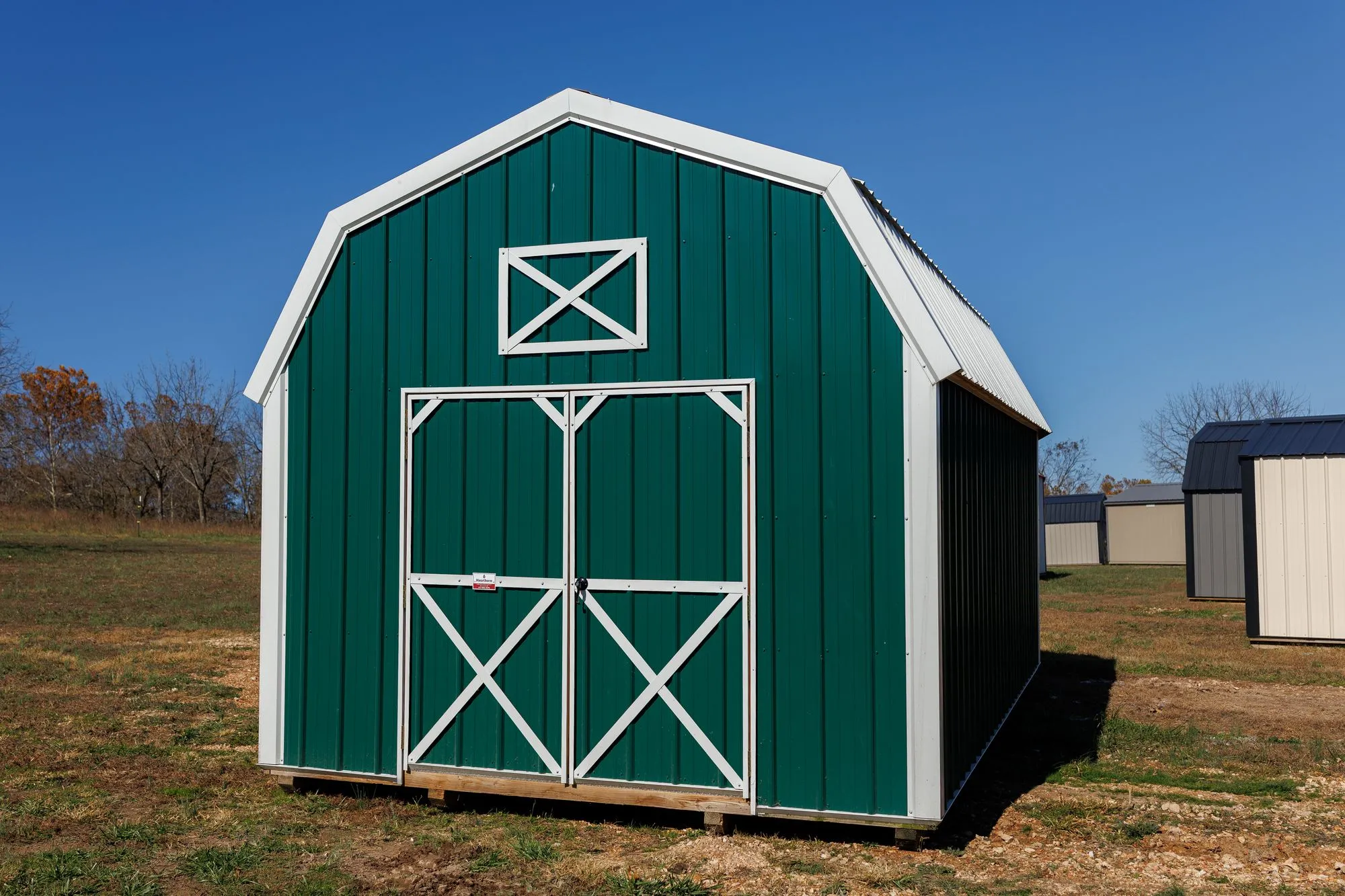 Lofted Barn with green metal siding with white trim