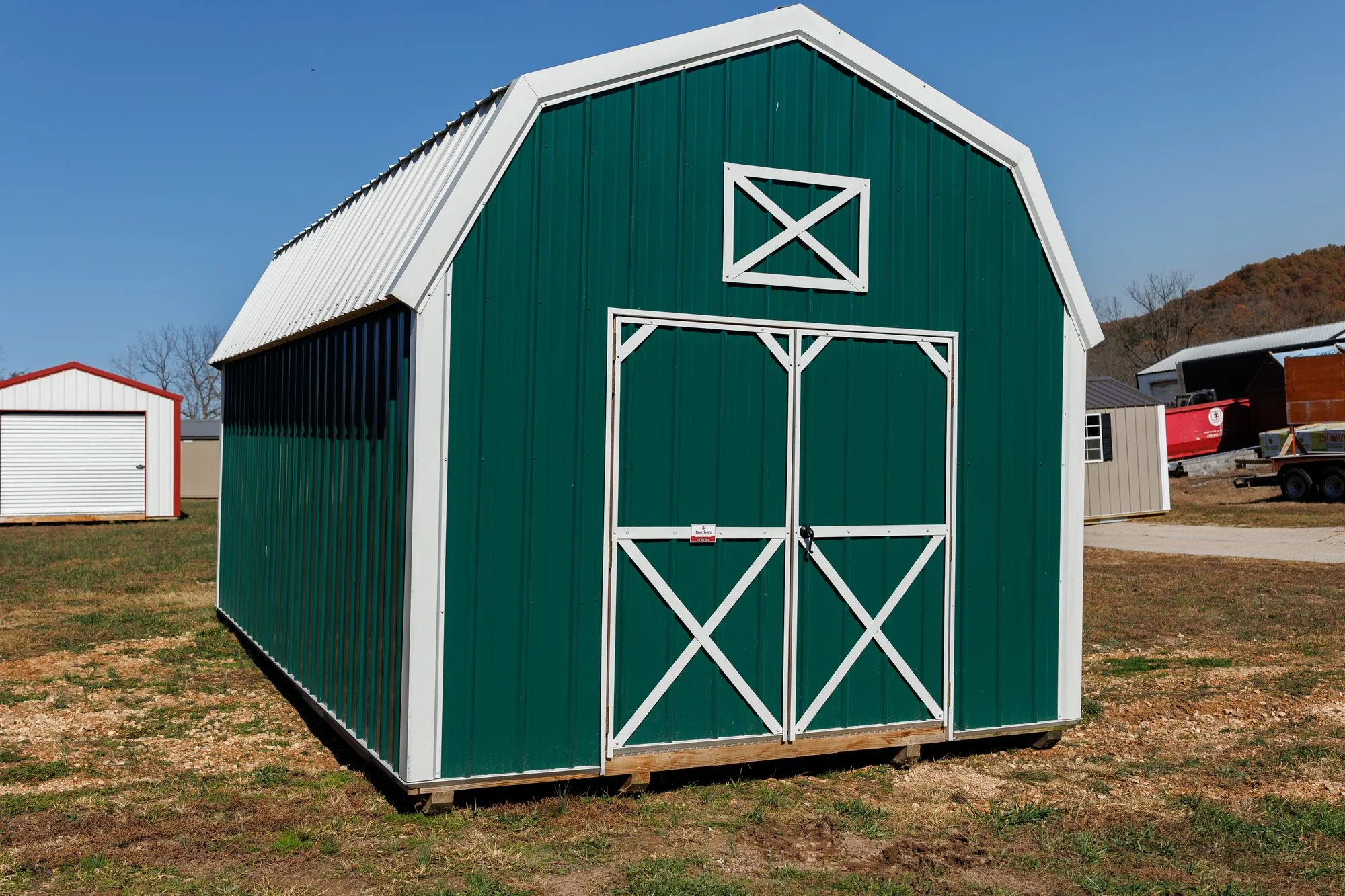 Lofted Barn with green metal siding with white trim