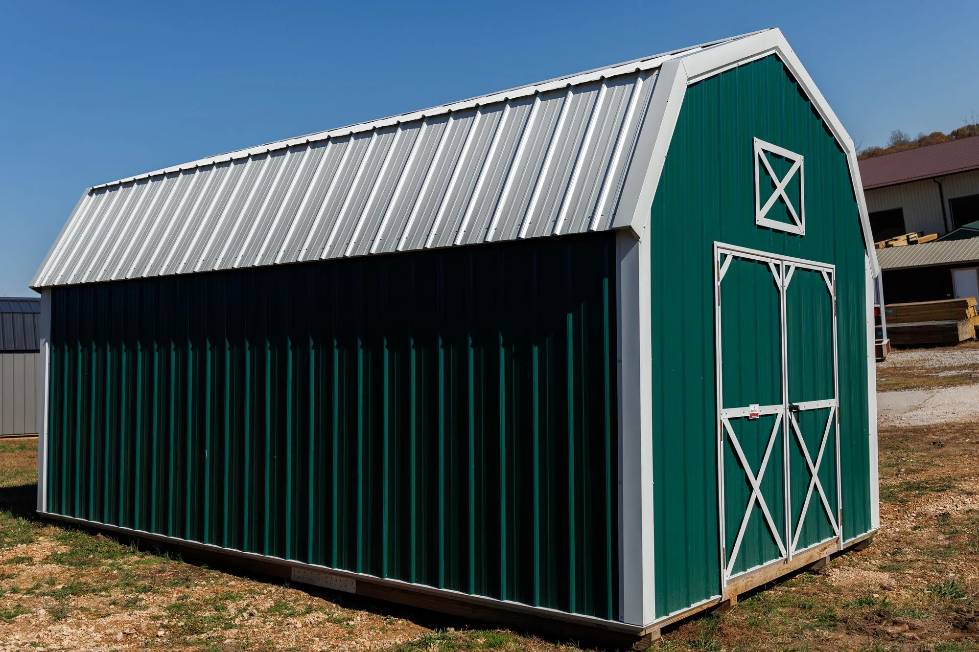 Lofted Barn with green metal siding with white trim