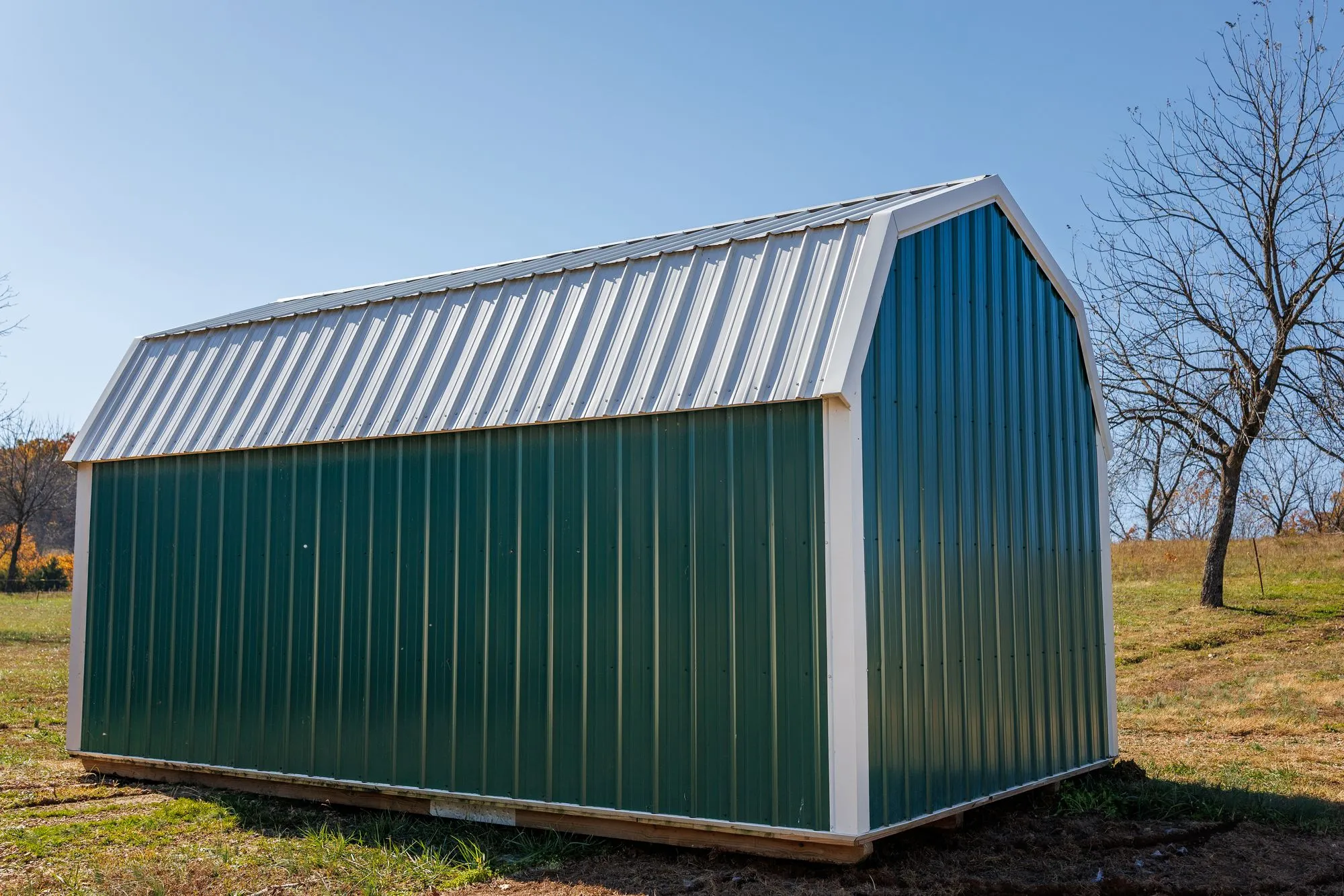 Lofted Barn with green metal siding with white trim