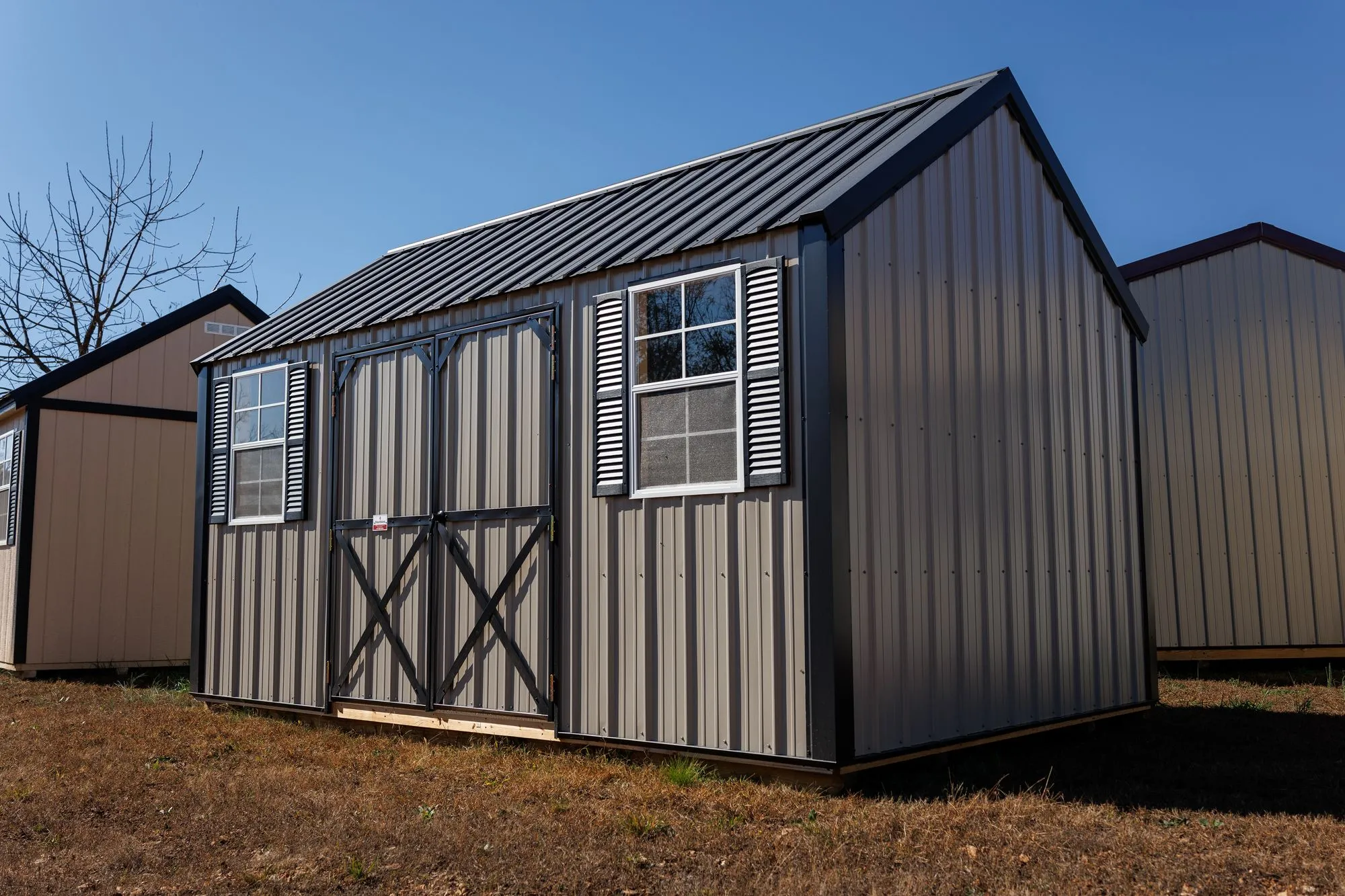 Lofted Garden Shed with clay metal siding, black trim and roof, black X-braced doors, two windows