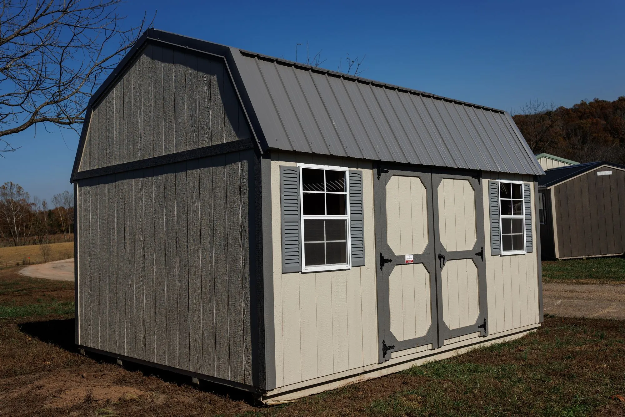 Lofted Garden Barn with cream and light-gray siding, charcoal trim, gray roof