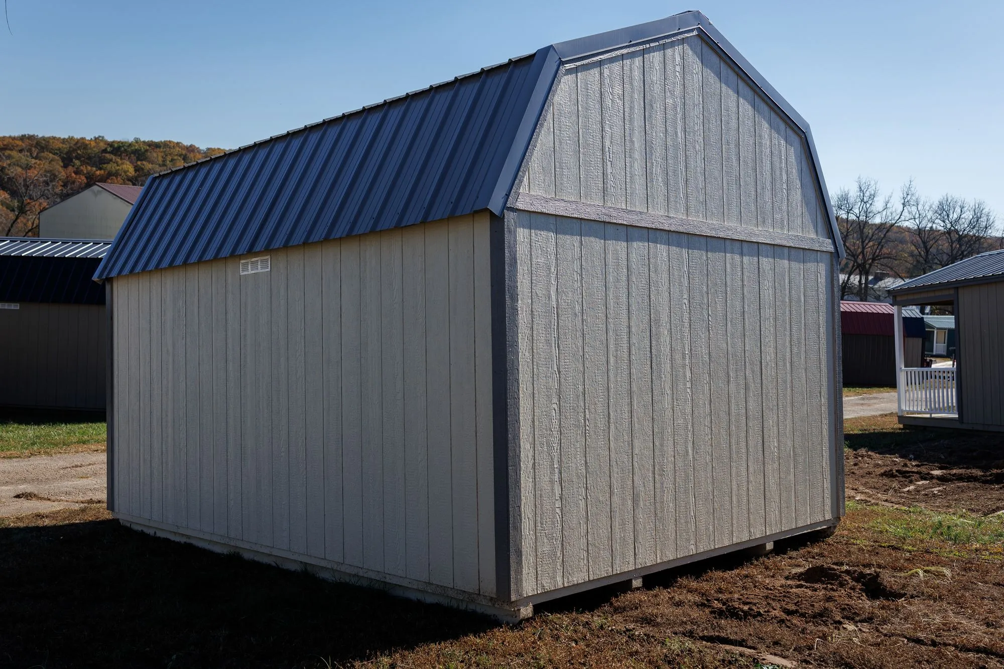Lofted Garden Barn with cream and light-gray siding, charcoal trim, gray roof